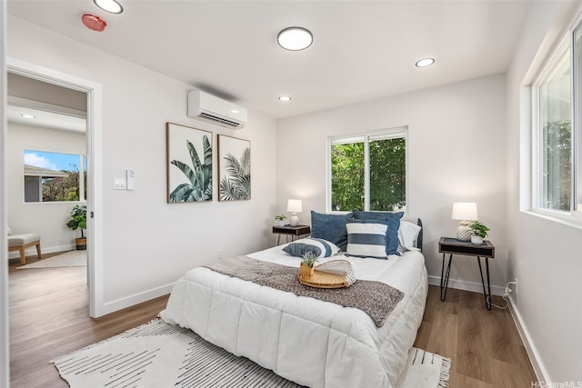 84-1001 Lahaina St Unit 1, Waianae, HI 96792 - bedroom with baseboards, recessed lighting, a wall mounted AC, and wood finished floors