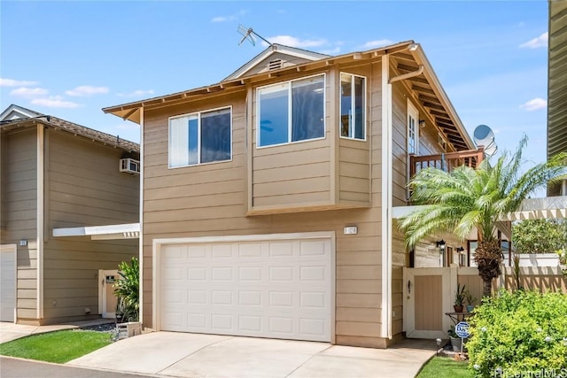 view of front of home featuring a garage, a wall mounted AC, fence, and concrete driveway