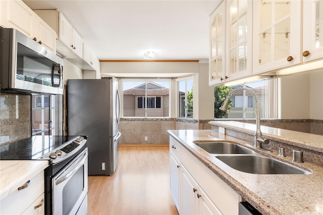 91-1026B Hoomaka St Unit 35, Ewa Beach, HI 96706 - kitchen with stainless steel appliances, a sink, light wood-style floors, white cabinets, and light stone countertops