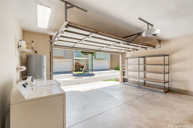 garage with water heater, washing machine and clothes dryer, and a garage door opener