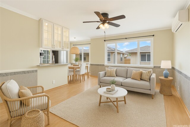 91-1026B Hoomaka St Unit 35, Ewa Beach, HI 96706 - living area featuring light wood-style flooring, ornamental molding, wainscoting, a wall mounted AC, and a ceiling fan