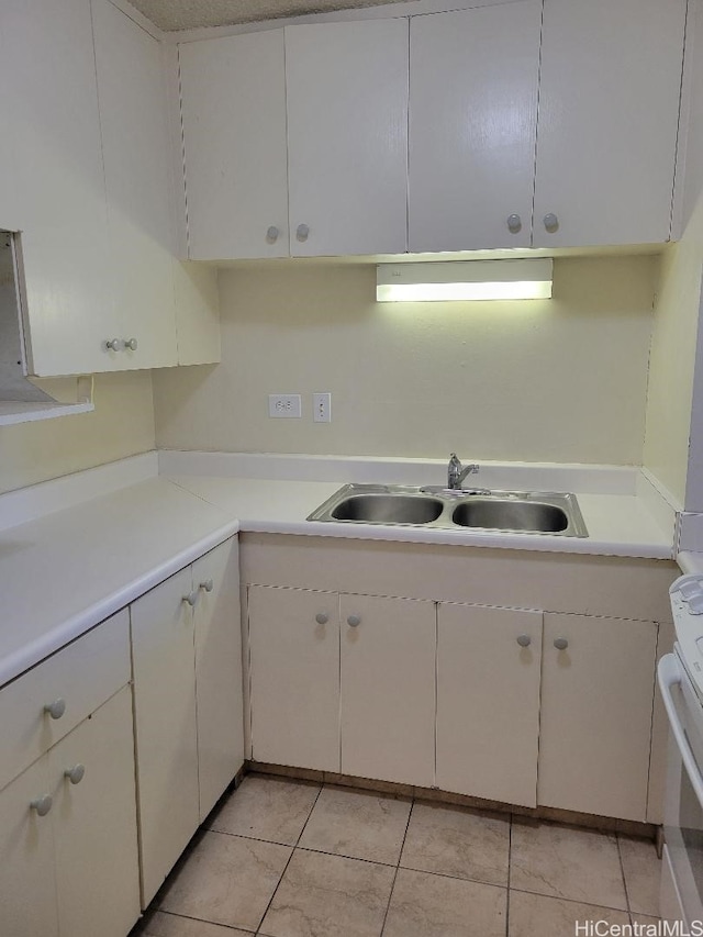 731 Amana St Unit 704, Honolulu, HI 96814 - kitchen featuring light countertops, a sink, light tile patterned flooring, and white cabinets