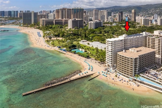 birds eye view of property featuring a water view, a view of the beach, and a view of city