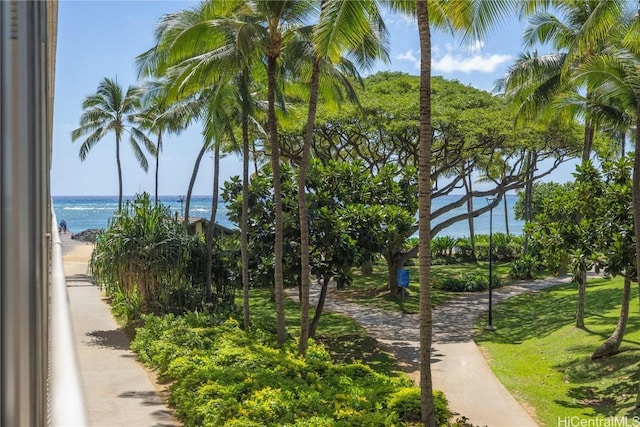 view of home's community with a water view and a yard