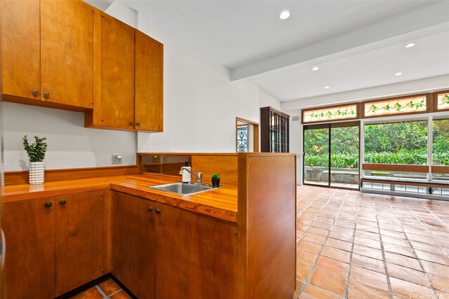 156 Forest Ridge Way, Honolulu, HI 96822 - kitchen with healthy amount of natural light, a peninsula, recessed lighting, and brown cabinets