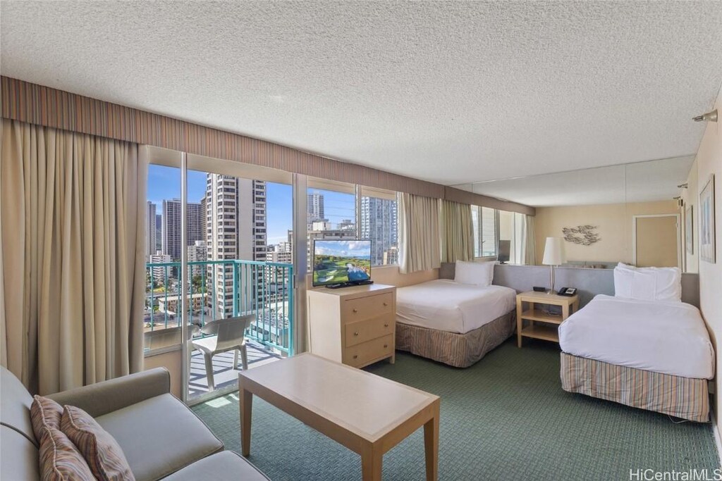 444 Kanekapolei St Unit 1501, Honolulu, HI 96815 - bedroom featuring carpet flooring, a textured ceiling, and access to outside