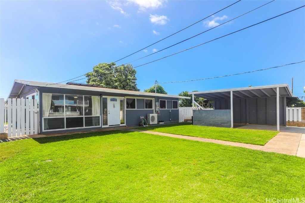 91-531 Onelua St, Ewa Beach, HI 96706 - back of house with fence, concrete driveway, and a yard