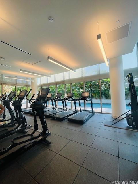 exercise room featuring floor to ceiling windows
