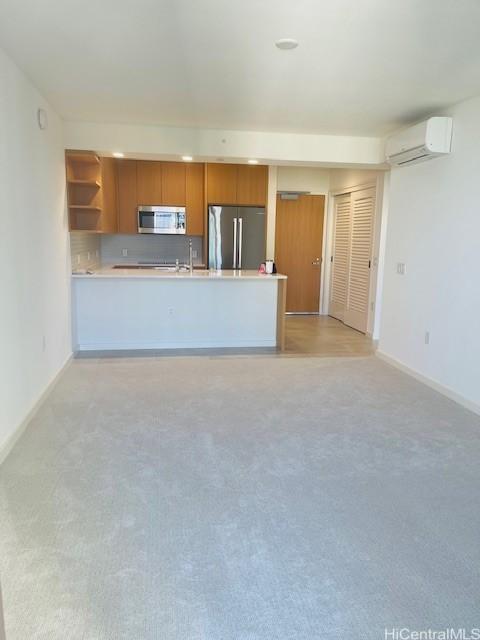 kitchen featuring a wall mounted air conditioner, light countertops, a peninsula, stainless steel appliances, and open shelves