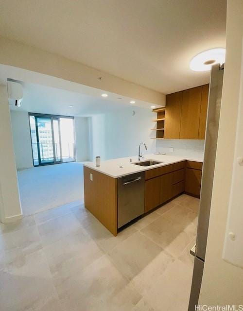 kitchen with a sink, open shelves, a wall unit AC, a peninsula, and brown cabinetry