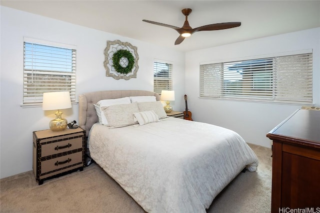 bedroom with light carpet and ceiling fan