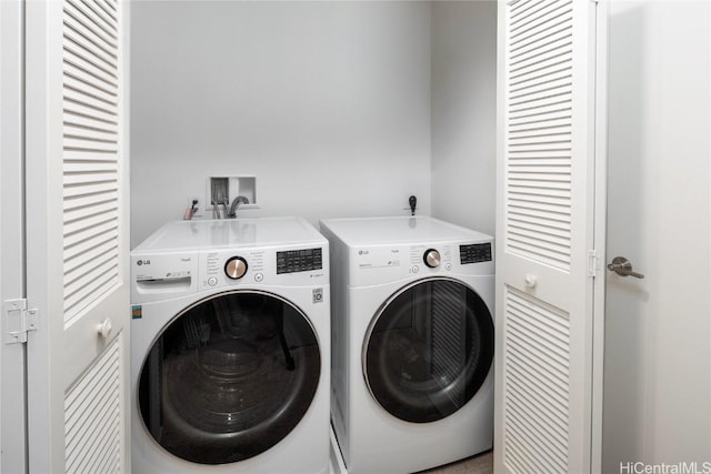 clothes washing area with separate washer and dryer and laundry area
