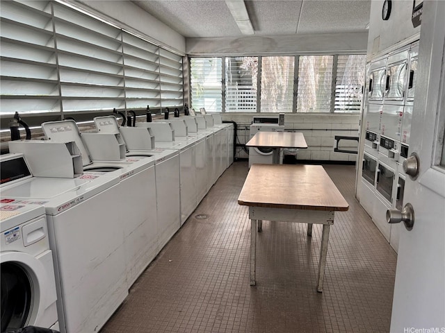 2847 Waialae Ave Unit 209, Honolulu, HI 96826 - shared laundry room with washing machine and clothes dryer, a textured ceiling, and estacked washer and dryer
