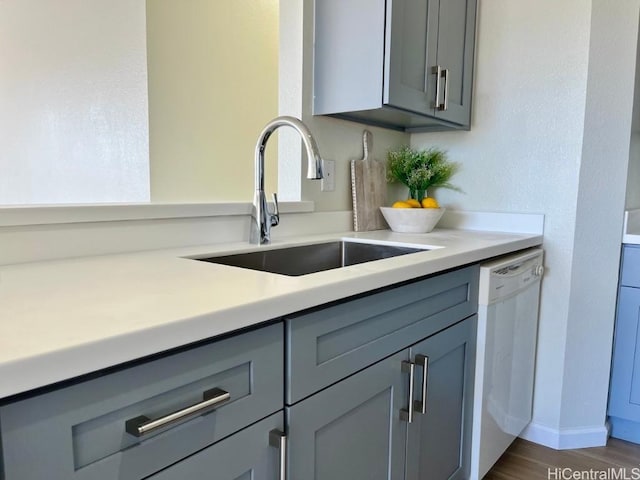 91-495 Puamaeole St Unit 38R, Ewa Beach, HI 96706 - kitchen featuring gray cabinets, light countertops, a sink, dark wood-style floors, and white dishwasher