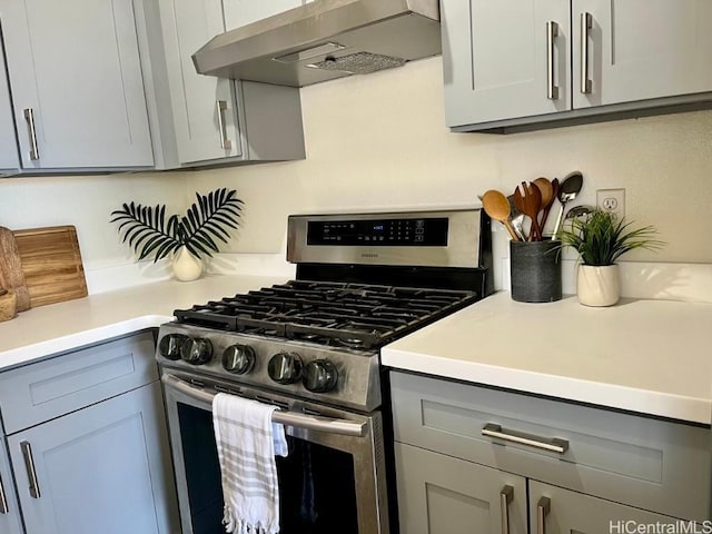 91-495 Puamaeole St Unit 38R, Ewa Beach, HI 96706 - kitchen featuring light countertops, stainless steel range with gas cooktop, gray cabinetry, and ventilation hood