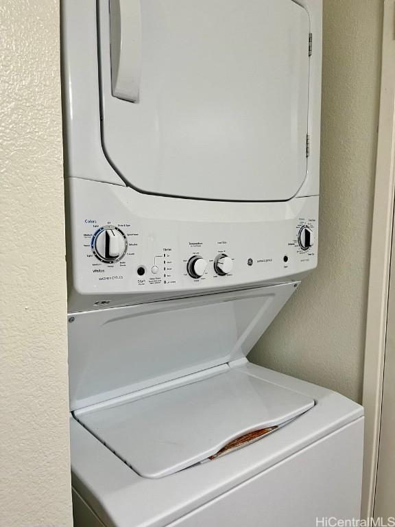 91-495 Puamaeole St Unit 38R, Ewa Beach, HI 96706 - washroom featuring stacked washer and clothes dryer, a textured wall, and laundry area