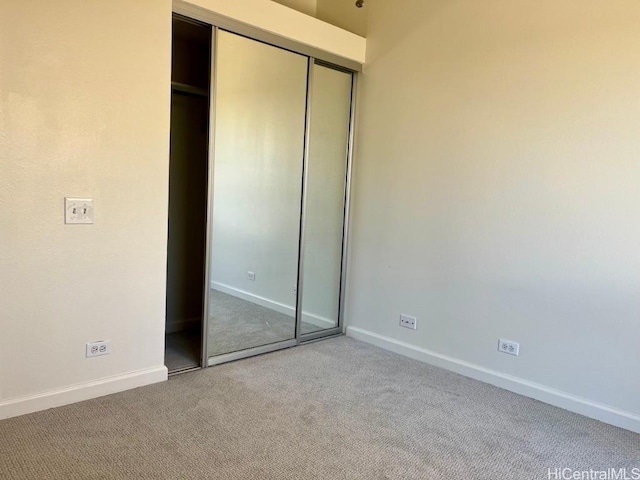 91-495 Puamaeole St Unit 38R, Ewa Beach, HI 96706 - unfurnished bedroom featuring a closet, carpet flooring, and baseboards