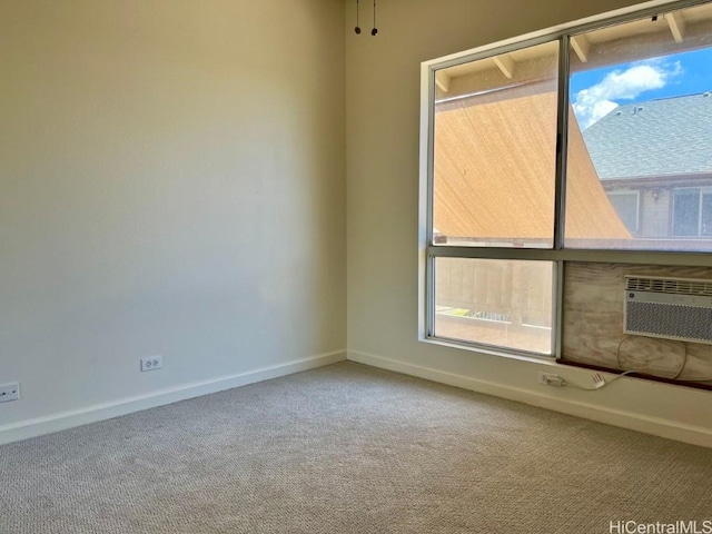 91-495 Puamaeole St Unit 38R, Ewa Beach, HI 96706 - spare room featuring baseboards, carpet flooring, and a wall unit AC