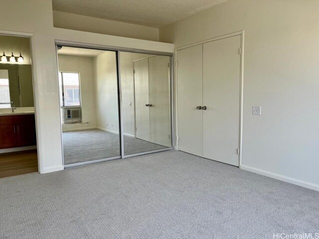 91-495 Puamaeole St Unit 38R, Ewa Beach, HI 96706 - unfurnished bedroom featuring carpet flooring, a sink, baseboards, and a textured ceiling