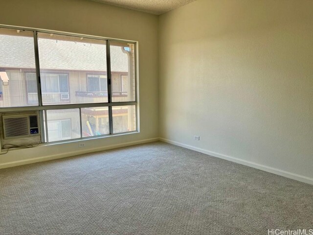 91-495 Puamaeole St Unit 38R, Ewa Beach, HI 96706 - carpeted empty room with baseboards, a textured ceiling, cooling unit, and a healthy amount of sunlight