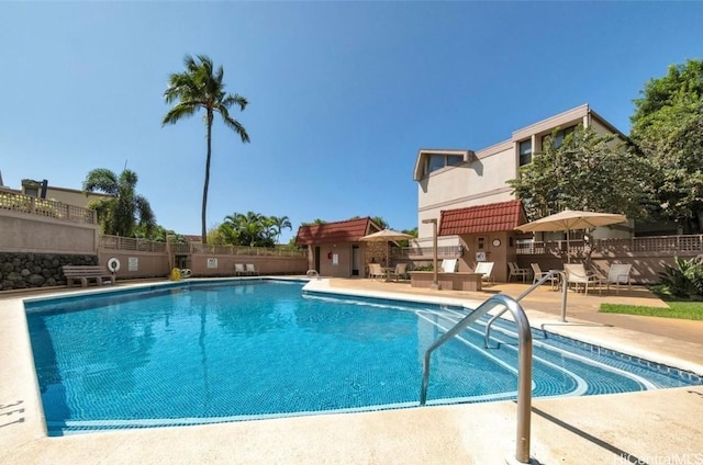pool with fence and a patio area