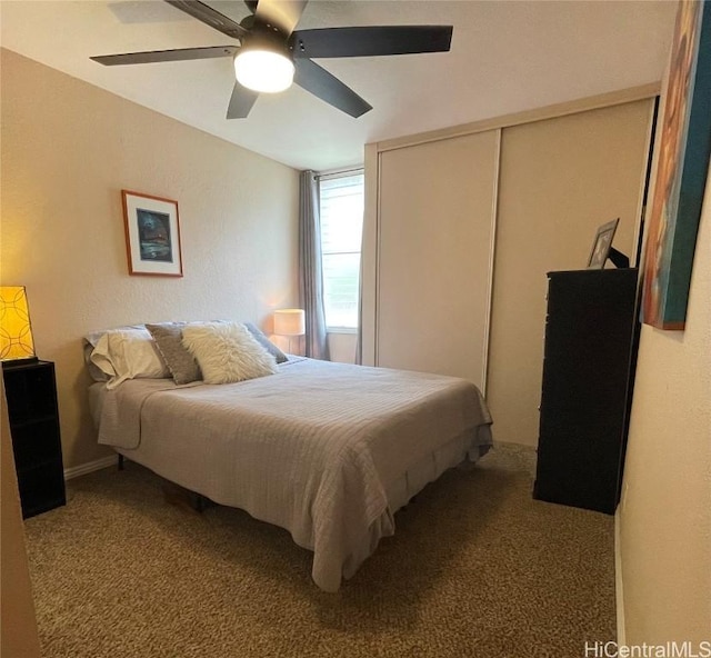 bedroom with carpet floors, a closet, and ceiling fan