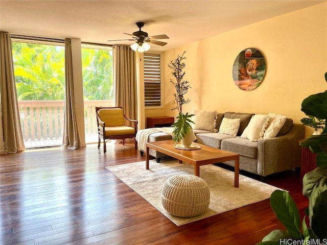 living room with floor to ceiling windows, dark wood-style flooring, and ceiling fan