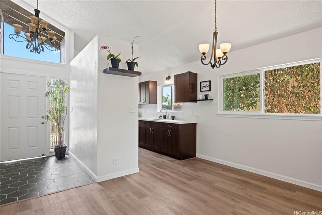 92-1158 Makamai Loop, Kapolei, HI 96707 - foyer with a chandelier, light wood-style flooring, and a textured ceiling