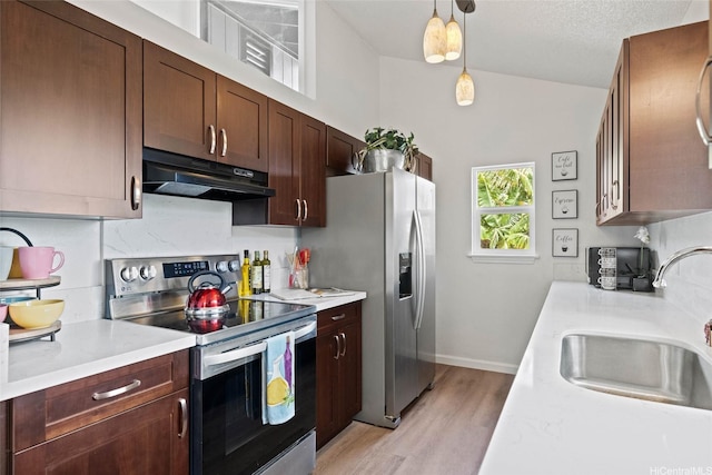 92-1158 Makamai Loop, Kapolei, HI 96707 - kitchen featuring appliances with stainless steel finishes, under cabinet range hood, light wood-type flooring, light countertops, and pendant lighting