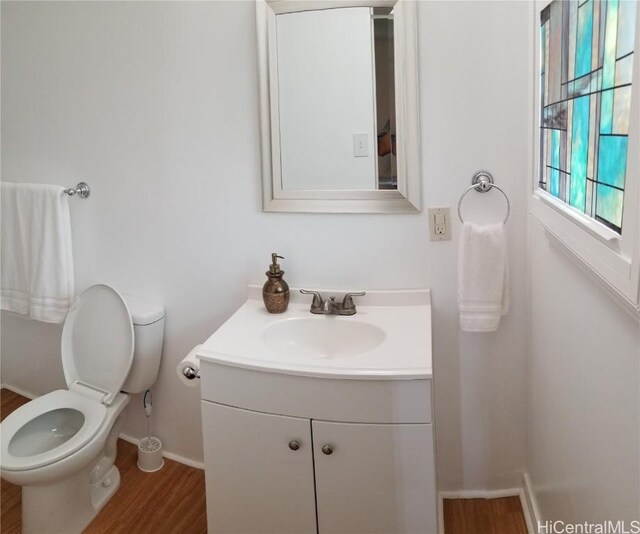 36 Ilima St, Wahiawa, HI 96786 - half bathroom with vanity, toilet, wood finished floors, and baseboards