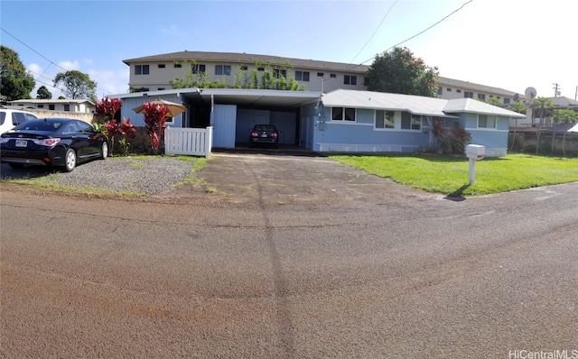 36 Ilima St, Wahiawa, HI 96786 - view of front of house featuring a carport, aphalt driveway, a front lawn, and fence