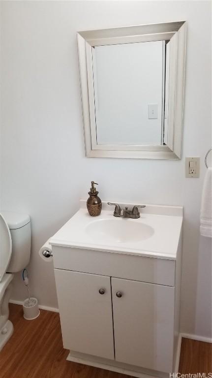 36 Ilima St, Wahiawa, HI 96786 - half bathroom with toilet, vanity, baseboards, and wood finished floors