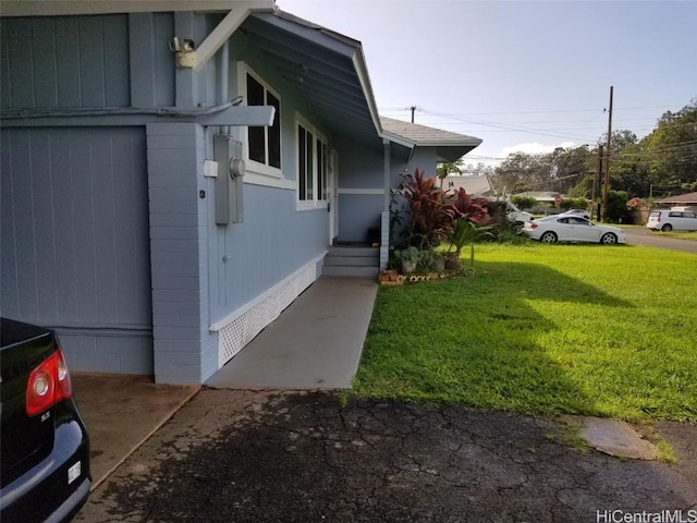 36 Ilima St, Wahiawa, HI 96786 - view of home's exterior with concrete block siding and a lawn