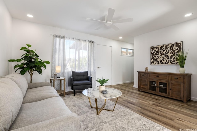 living room featuring wood finished floors, a ceiling fan, and recessed lighting