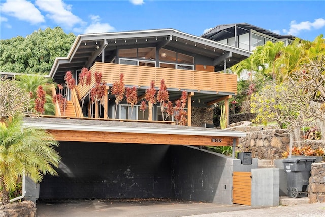 rear view of property featuring a balcony