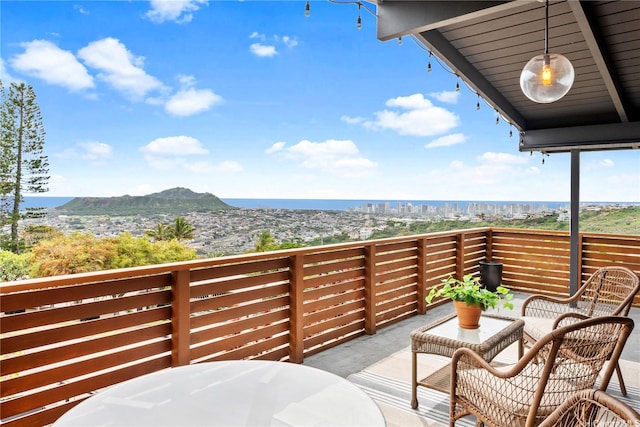 balcony featuring outdoor dining area and a mountain view