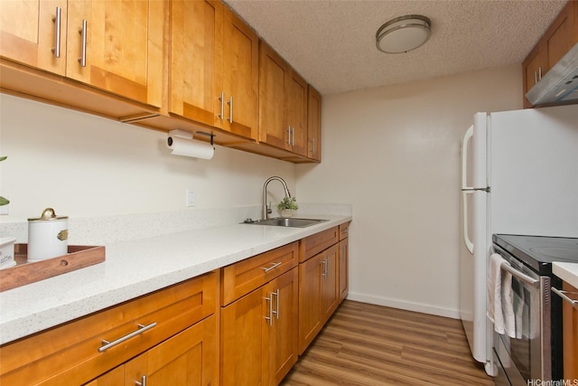 2334 Kapiolani Blvd Unit 301, Honolulu, HI 96826 - kitchen featuring electric range, a sink, brown cabinetry, light wood-type flooring, and a textured ceiling