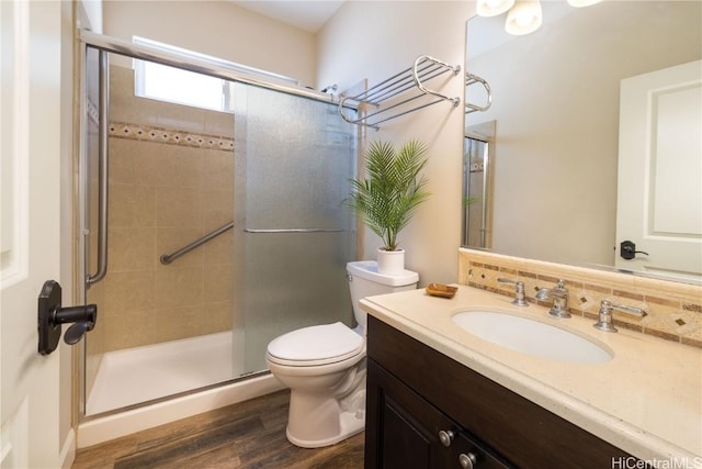 91-1072 Waikapoo St, Ewa Beach, HI 96706 - bathroom featuring decorative backsplash, a shower stall, wood finished floors, toilet, and vanity