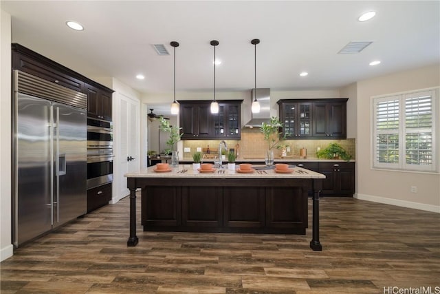 91-1072 Waikapoo St, Ewa Beach, HI 96706 - kitchen with visible vents, wall chimney exhaust hood, dark brown cabinetry, and stainless steel appliances