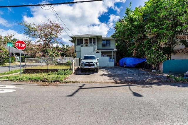view of front of home featuring aphalt driveway and fence