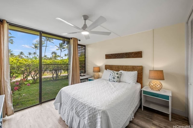 57-101 Kuilima Dr Unit 544C, Kahuku, HI 96731 - bedroom featuring wood finished floors, floor to ceiling windows, access to exterior, ceiling fan, and a closet
