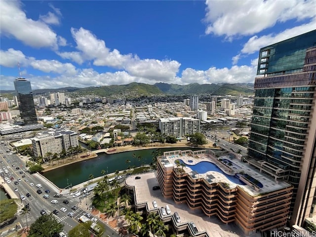 exterior space with a city view and a water view