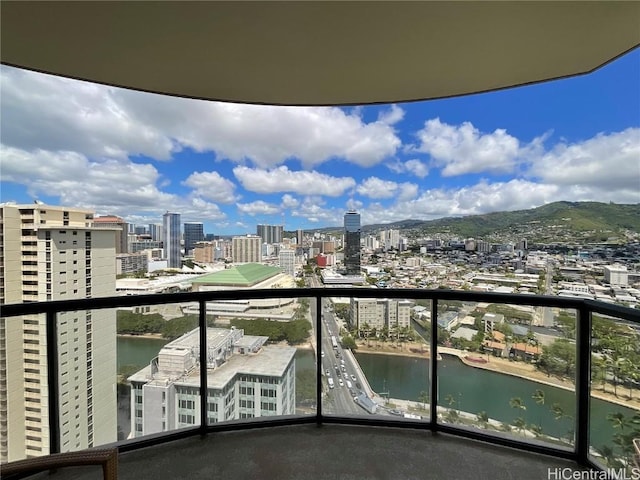balcony with a view of city and a water view