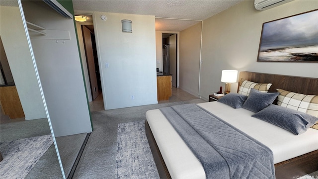 bedroom with an AC wall unit, carpet, a closet, and a textured ceiling