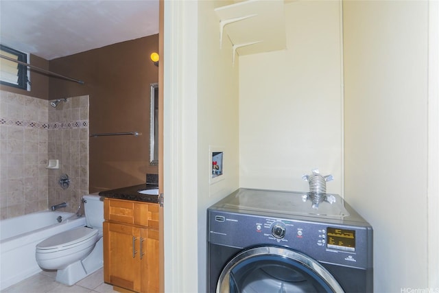 full bath with washer / clothes dryer, toilet, tile patterned floors, bathing tub / shower combination, and vanity