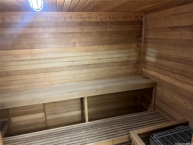 sauna / steam room featuring wooden ceiling and wood walls