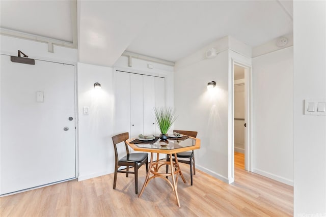 dining room featuring baseboards and light wood-style flooring