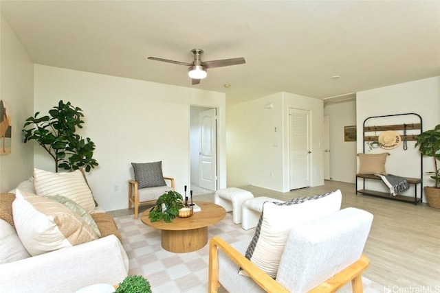 living room with a ceiling fan and light wood-style floors