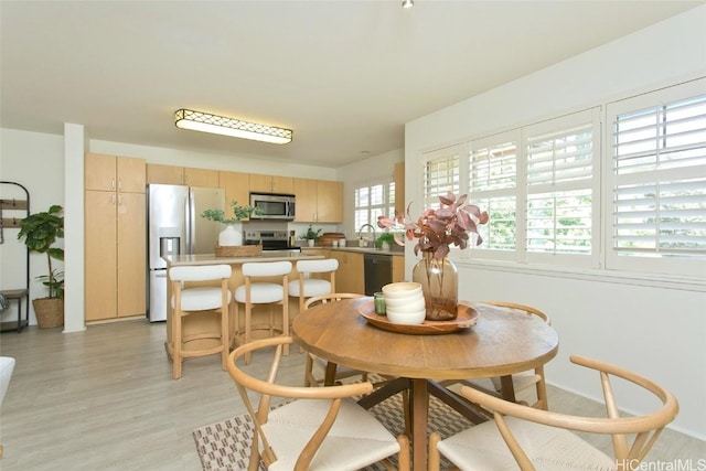 dining area with light wood-style flooring