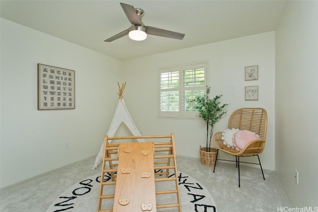 playroom with carpet and ceiling fan